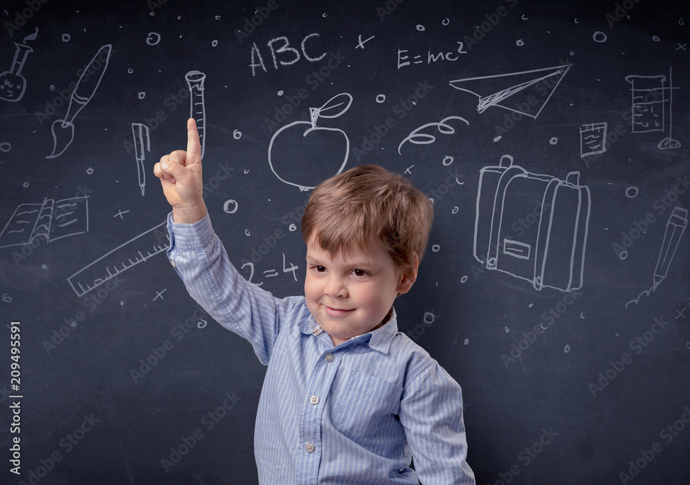 Smart little kid in front of a drawn up blackboard ruminate