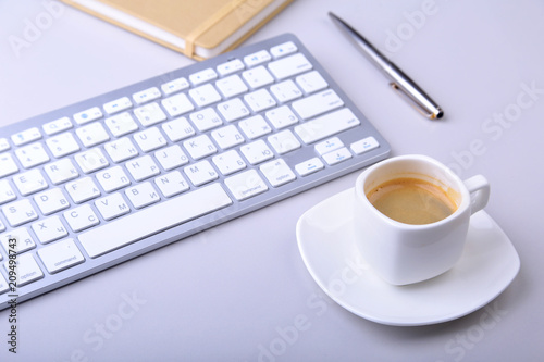 office table with notebook, computer keyboard,, cup of coffee, tablet pc. copy space.