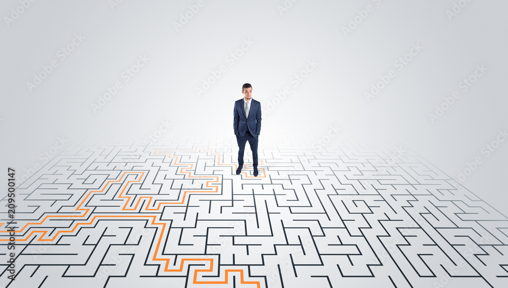 Young entrepreneur standing in a middle of a labyrinth with the solution
Young entrepreneur standing in a middle of a labyrinth with the solution