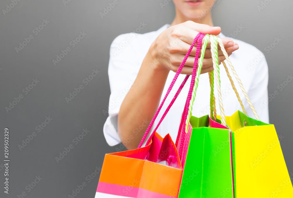 Female holding colorful shopping bags. 