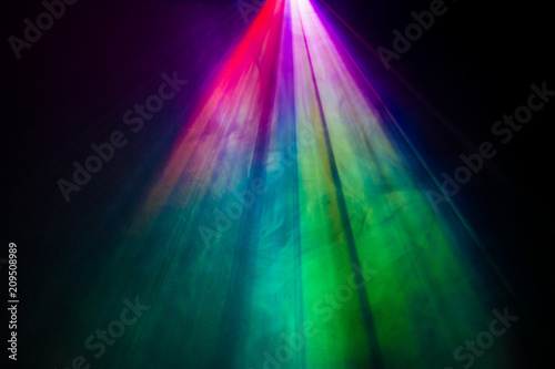beautiful rainbow color wide lens projector with light beam for movie and cinema at night . smoke texture spotlight . screening for multimedia . black background .