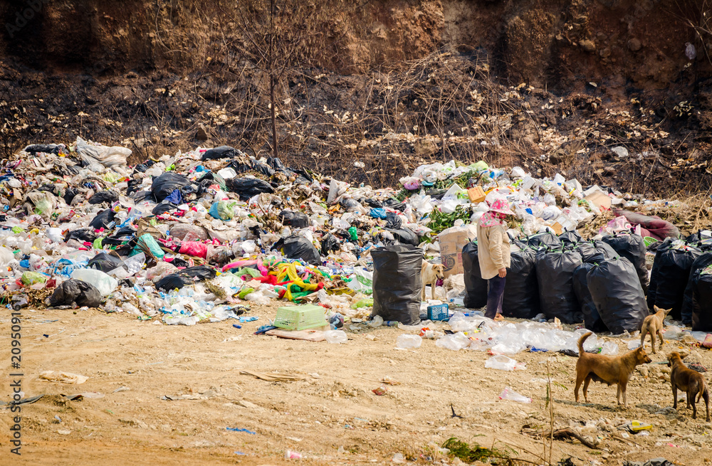 RATCHABURI PROVINCE, THAILAND-MARCH 14: People working in Municipal waste disposal open dump process. Dump site at Ratchaburi Province on MARCH 14 , 2016 in RATCHABURI PROVINCE THAILAND