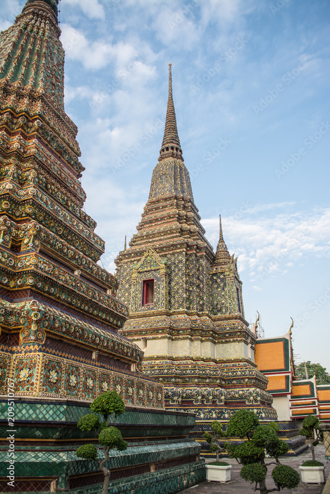 Fototapeta premium Pagoda is in Wat Pho that was named as the temple of the pagoda or chedi that are decorated with yellow glaze or glazed tiles or dark blue. 