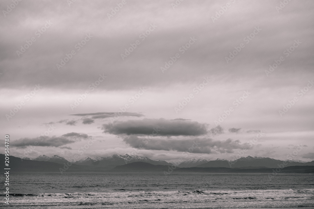 Fototapeta premium Beautiful scene of the beach with snow mountain at dusk. Black and white effect.