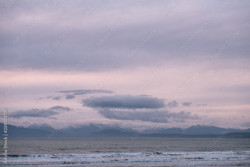 Beautiful scene of the beach with snow mountain at dusk. Beautiful scene of the beach with snow mountain at dusk.