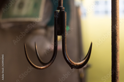 brown iron hook in market . hanging of object cuisine . sharp tools