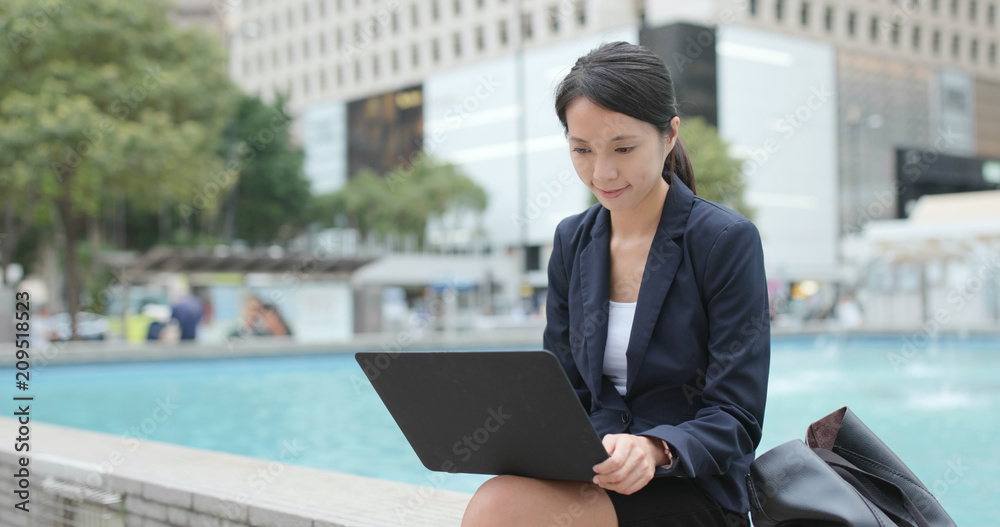 Fototapeta premium Businesswoman use of laptop computer at outdoor
