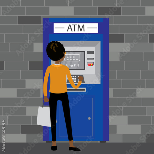 African-American woman standing near ATM machine