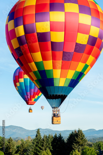 Hot air balloons on beautiful sunny morning over trees © just.b photography