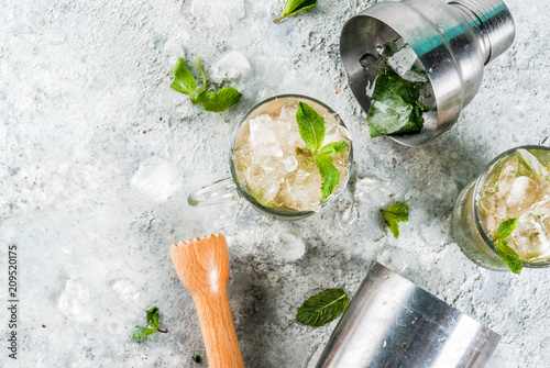 Cold summer beverage, mint julep cocktail drink, grey stone background copy space