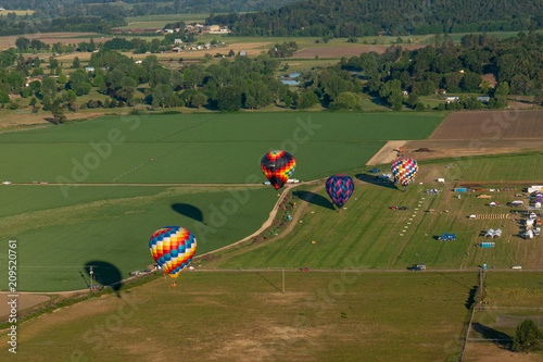 Hot air balloons landing in a field