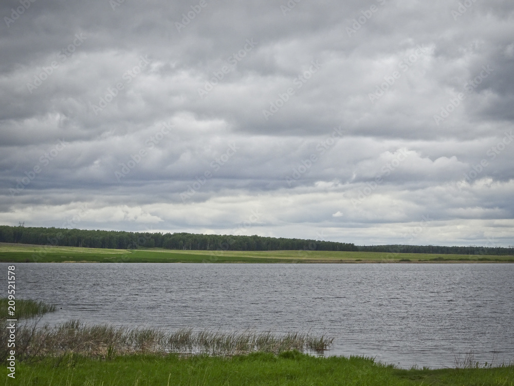 Summer landscape: a lake in cloudy weather