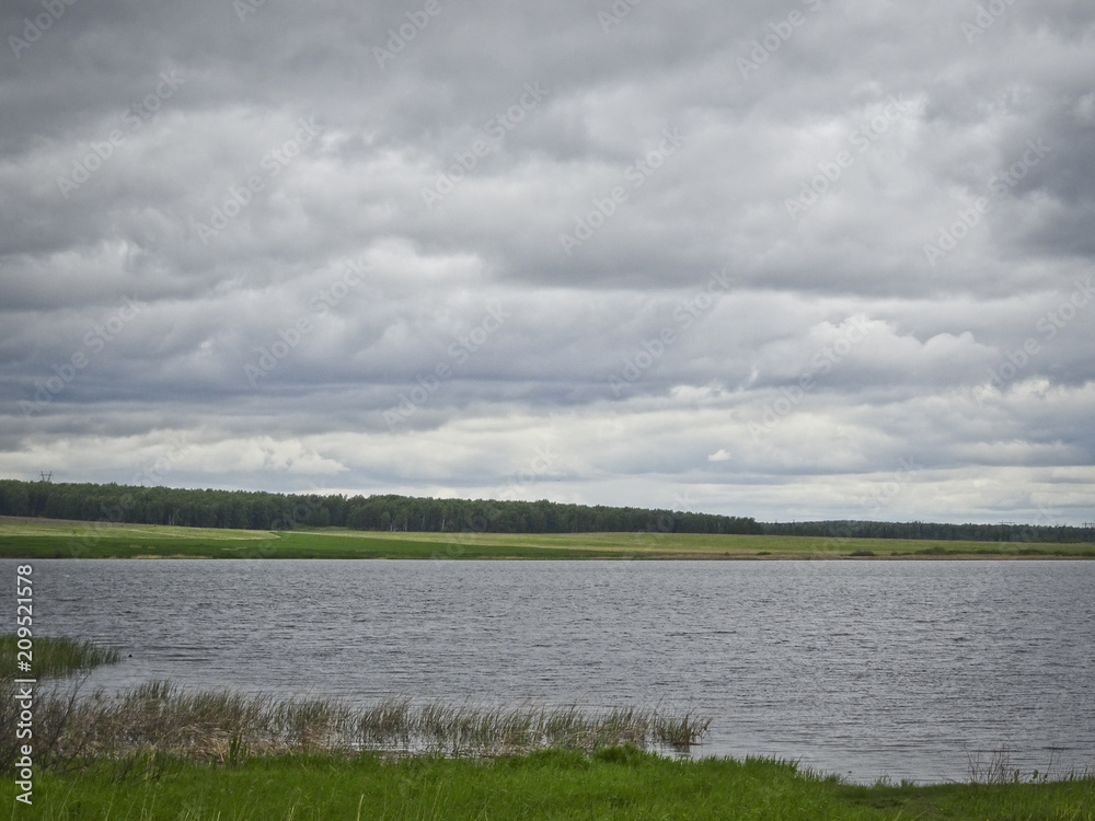 Fototapeta premium Summer landscape: a lake in cloudy weather
