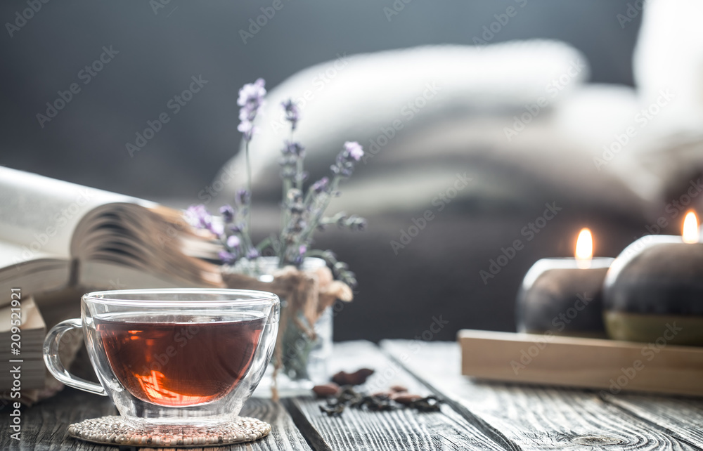 a cup of tea with a book in the interior - obrazy, fototapety, plakaty 