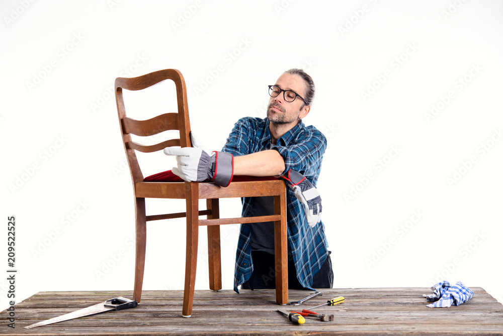 worker in blue shirt repair old chair worker in blue shirt repair old chair