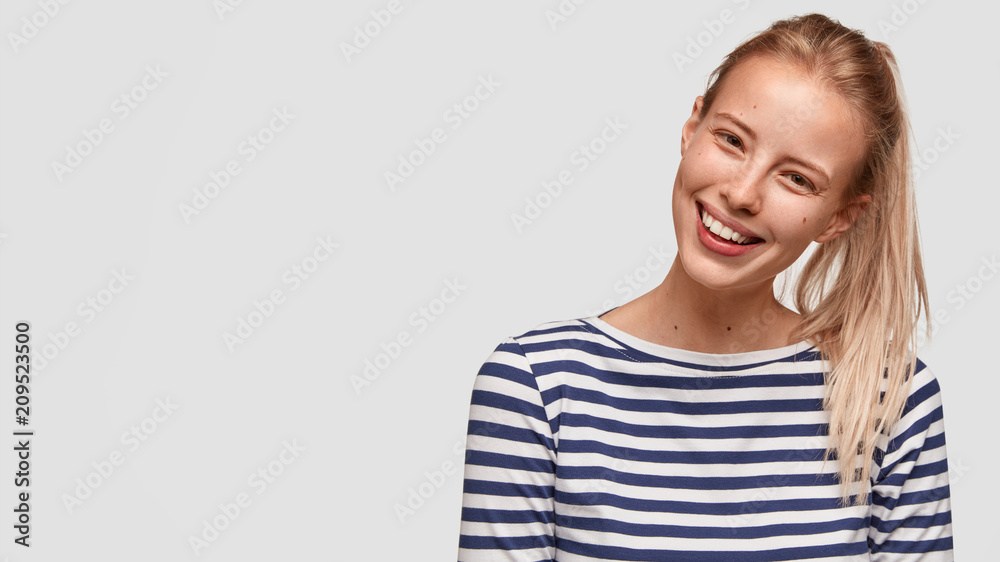Cheerful pretty young female with positve expression, looks friendly, has pleasant talk with customer, isolated over white background, copy space for advertisement. Happy student helps groupmates Cheerful pretty young female with positve expression, looks friendly, has pleasant talk with customer, isolated over white background, copy space for advertisement. Happy student helps groupmates