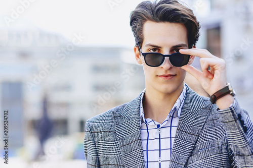 Stylish man in sunglasses on street