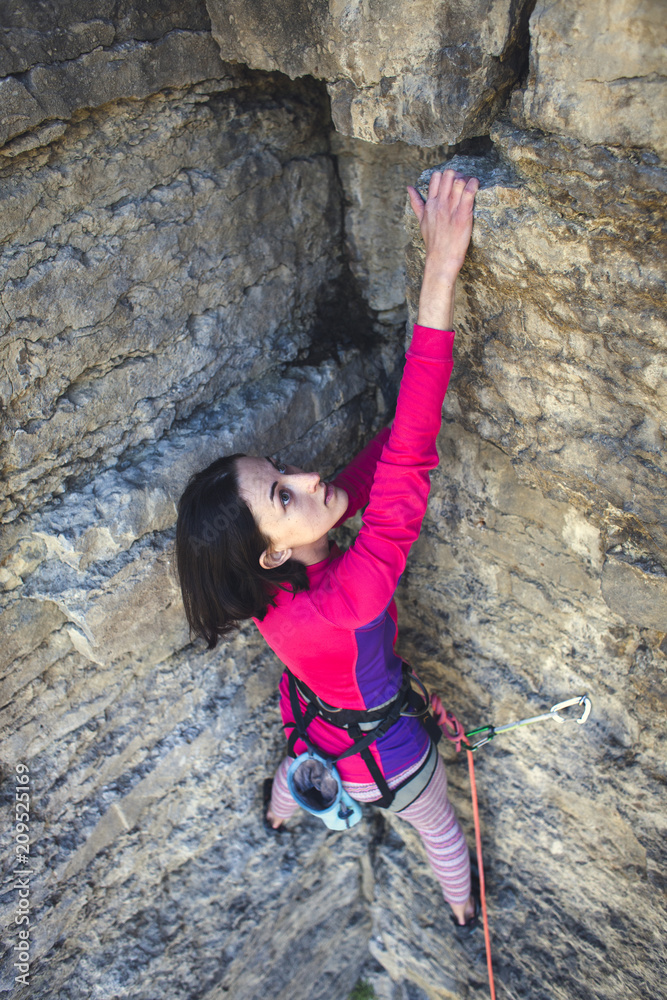 The woman is on a rock. The woman is on a rock.