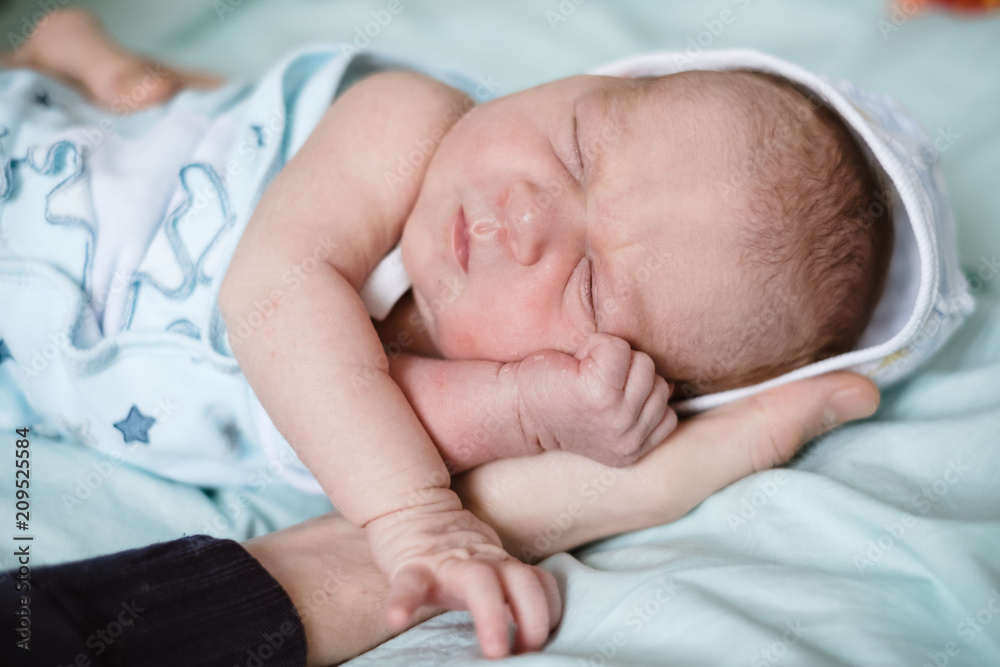 Newborn baby sleeping at home. Close up hands Newborn baby sleeping at home. Close up hands