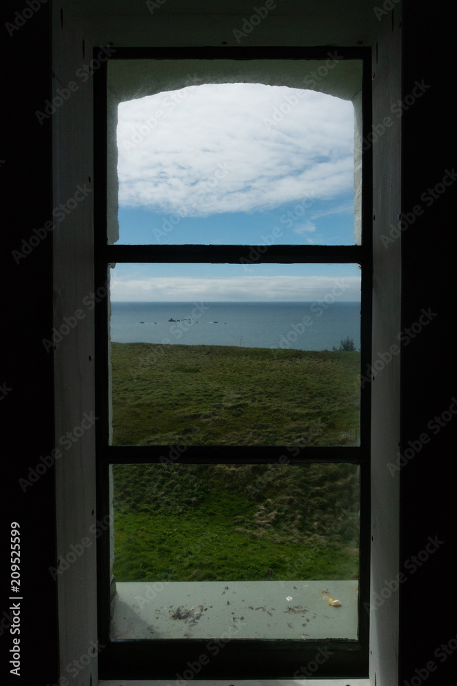Fototapeta premium A view of the Pacific Ocean from inside the Cape Blanco LIghthouse on the Oregon Coast