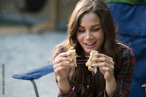 Young woman eating smores 