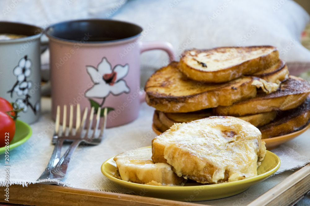 Delicious breakfast in bed with toast and a big cup of coffee Delicious breakfast in bed with toast and a big cup of coffee