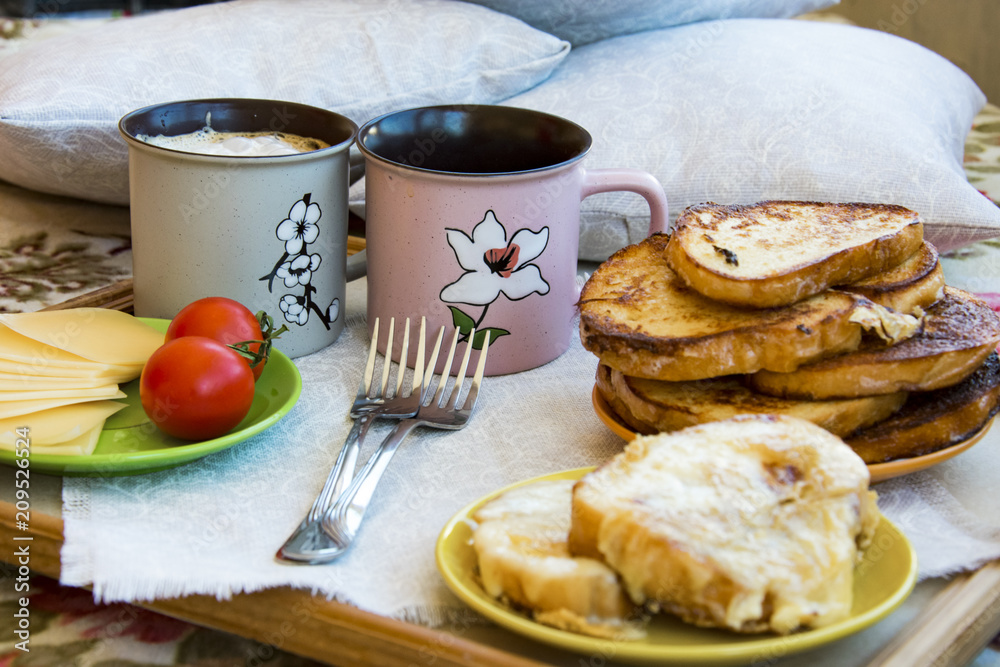 Delicious breakfast in bed with toast and a big cup of coffee Delicious breakfast in bed with toast and a big cup of coffee