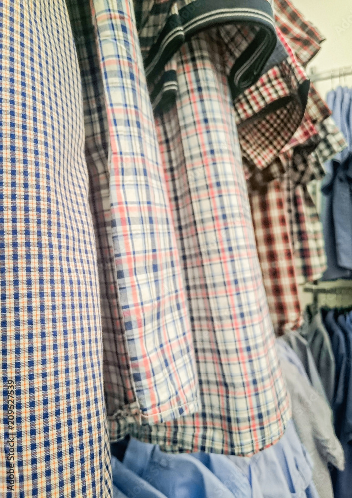 Checkered shirts on the hanger in the store Checkered shirts on the hanger in the store