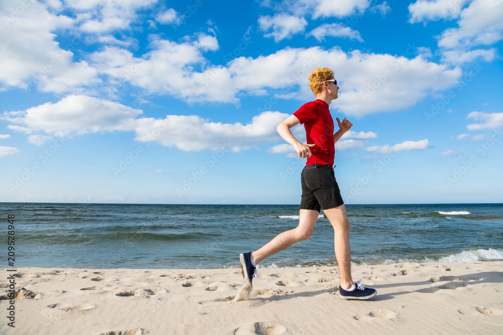 Man running, jumping on beach Man running, jumping on beach