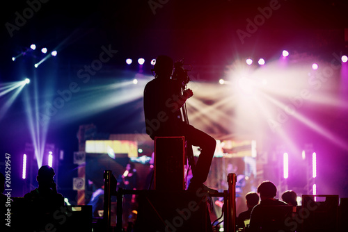 professional cameraman record live concert with beam spot and light performance © whyframeshot