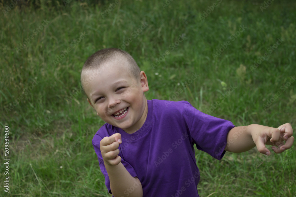 the boy laughs and plays around against nature the boy laughs and plays around against nature