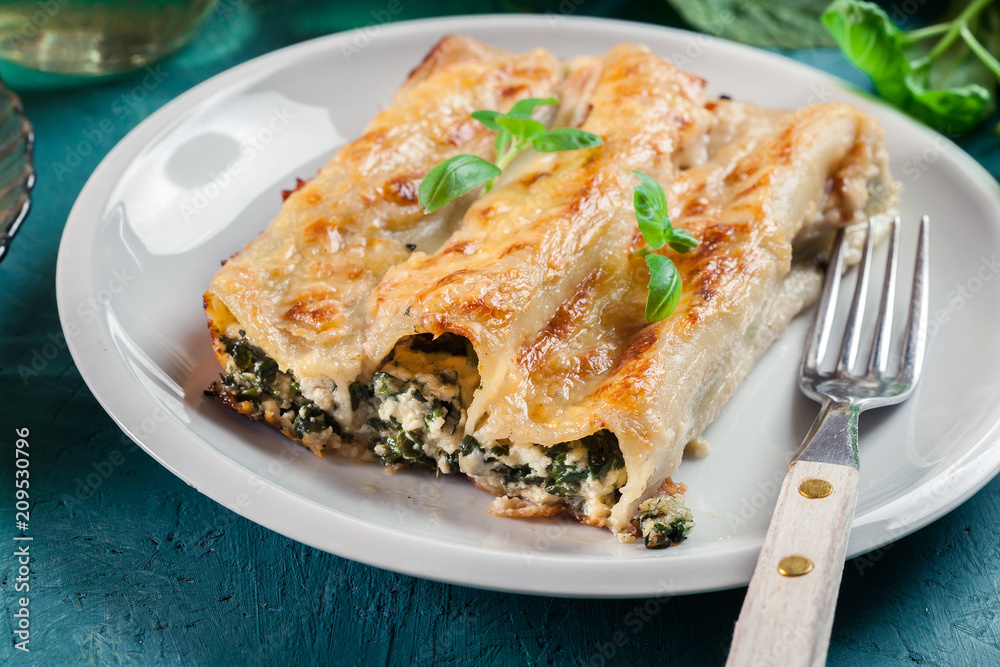 Portion of cannelloni stuffed with spinach Portion of cannelloni stuffed with spinach