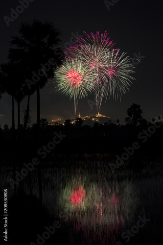 Beautiful colorful firework festival at night sky in Phra Nakhon Khiri (Khao Wang) with sugar palm Phetchaburi