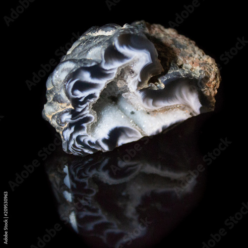 Natural geode polished agate on a black background