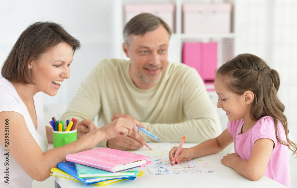 Parents and little girl doing homework Parents and little girl doing homework