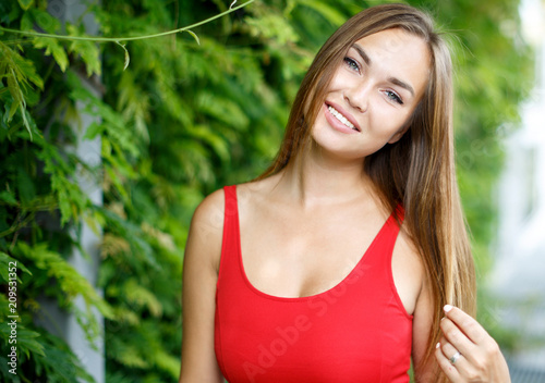 portrait of beautiful girl outdoors in red dress