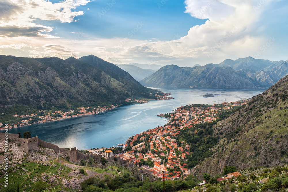 Panoramic view from above on the old city Kotor, bay in Adriatic sea and mountains in Montenegro at sunset time, gorgeous nature landscape