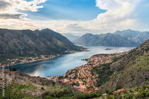 Panoramic view from above on the old city Kotor, bay in Adriatic sea and mountains in Montenegro at sunset time, gorgeous nature landscape