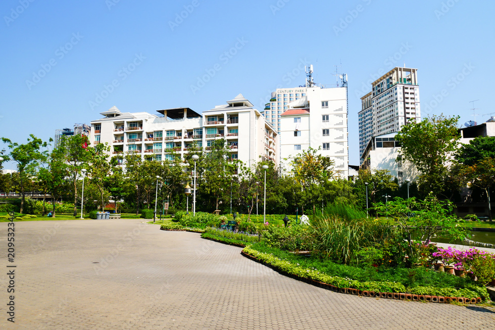 Fototapeta premium BANGKOK, THAILAND - MARCH 11, 2017: A walk way and green forest in the Santiphab park, the place for people to relax in Bangkok in the afternoon with fresh air.