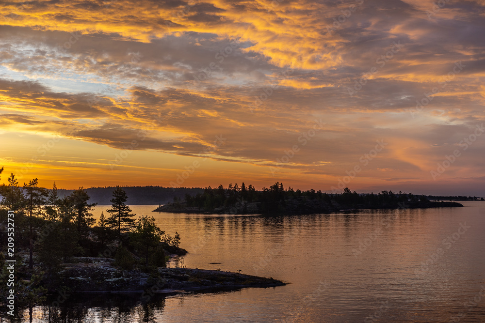 Clouds over the water. Sunrise. Gold clouds. Karelia Russia. Nature of Karelia. Ladoga lake.