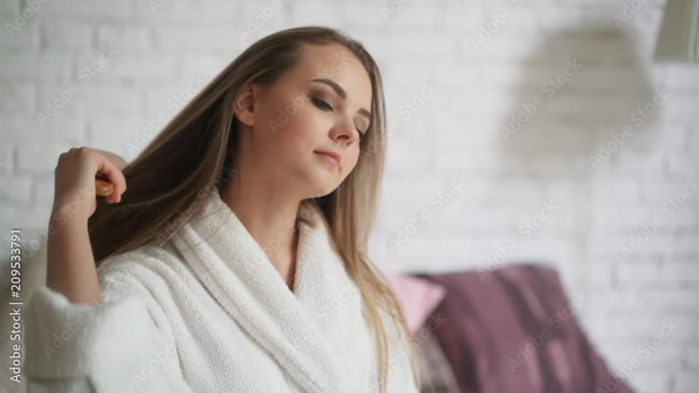 Beautiful woman with long hair angry about loosing it after brushing Beautiful woman with long hair angry about loosing it after brushing
