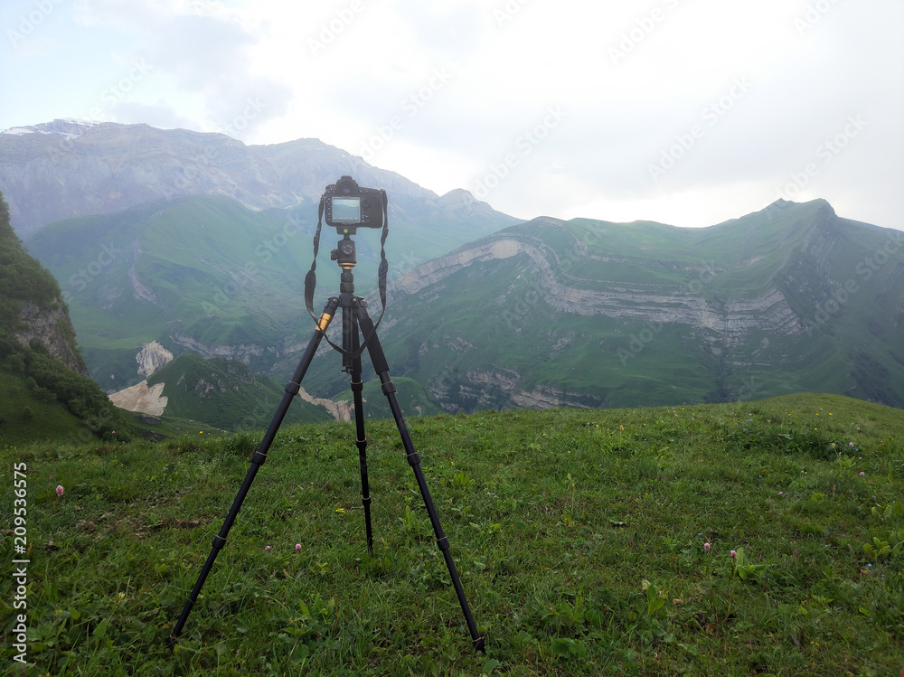 Camera on a tripod, shooting foggy mountains, mobile photo