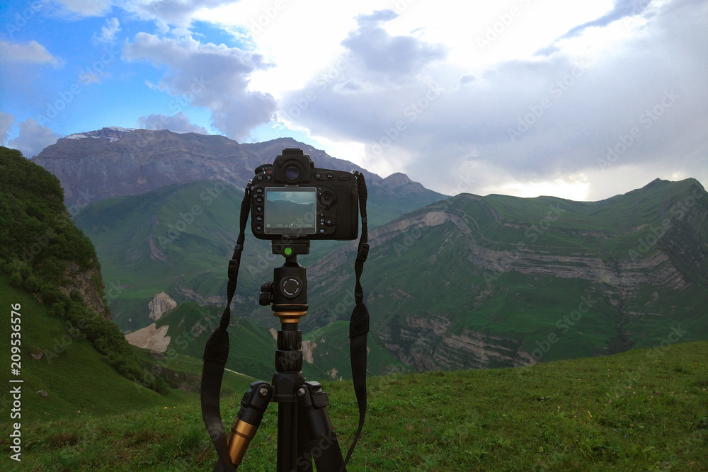 Camera on a tripod, shooting mountains scenery, mobile photo