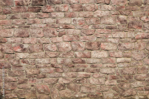 Wall of red stone. Background   texture.