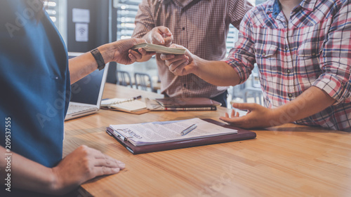 business partners signing contract to borrow money from investor to invest at own business