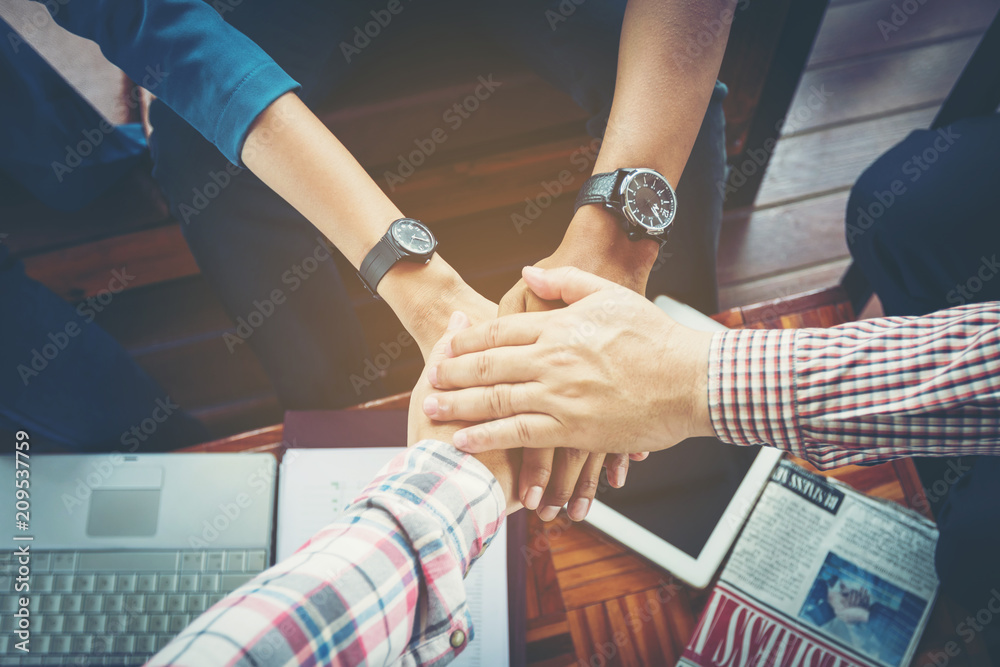 business people joined hand at meeting desk