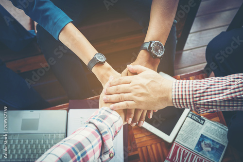 business people joined hand at meeting desk