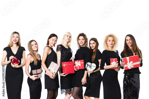 Group of fashion women in black dress with gifts in hands isolated.