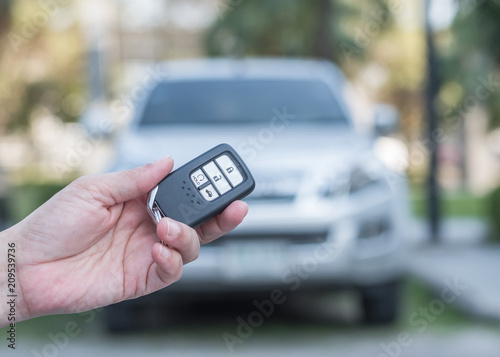 Car valet parking service business concept with people handling car key on blur parking lot background