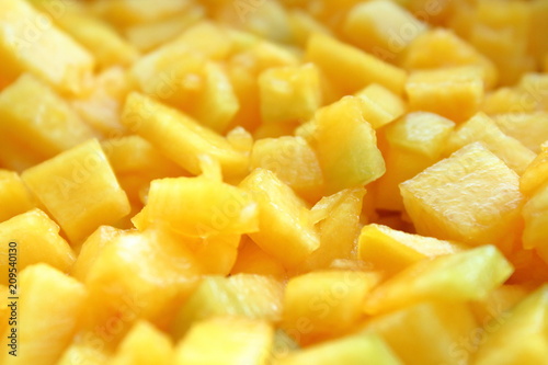 Pumpkin cut into small pieces. Close-up. Background. Texture.